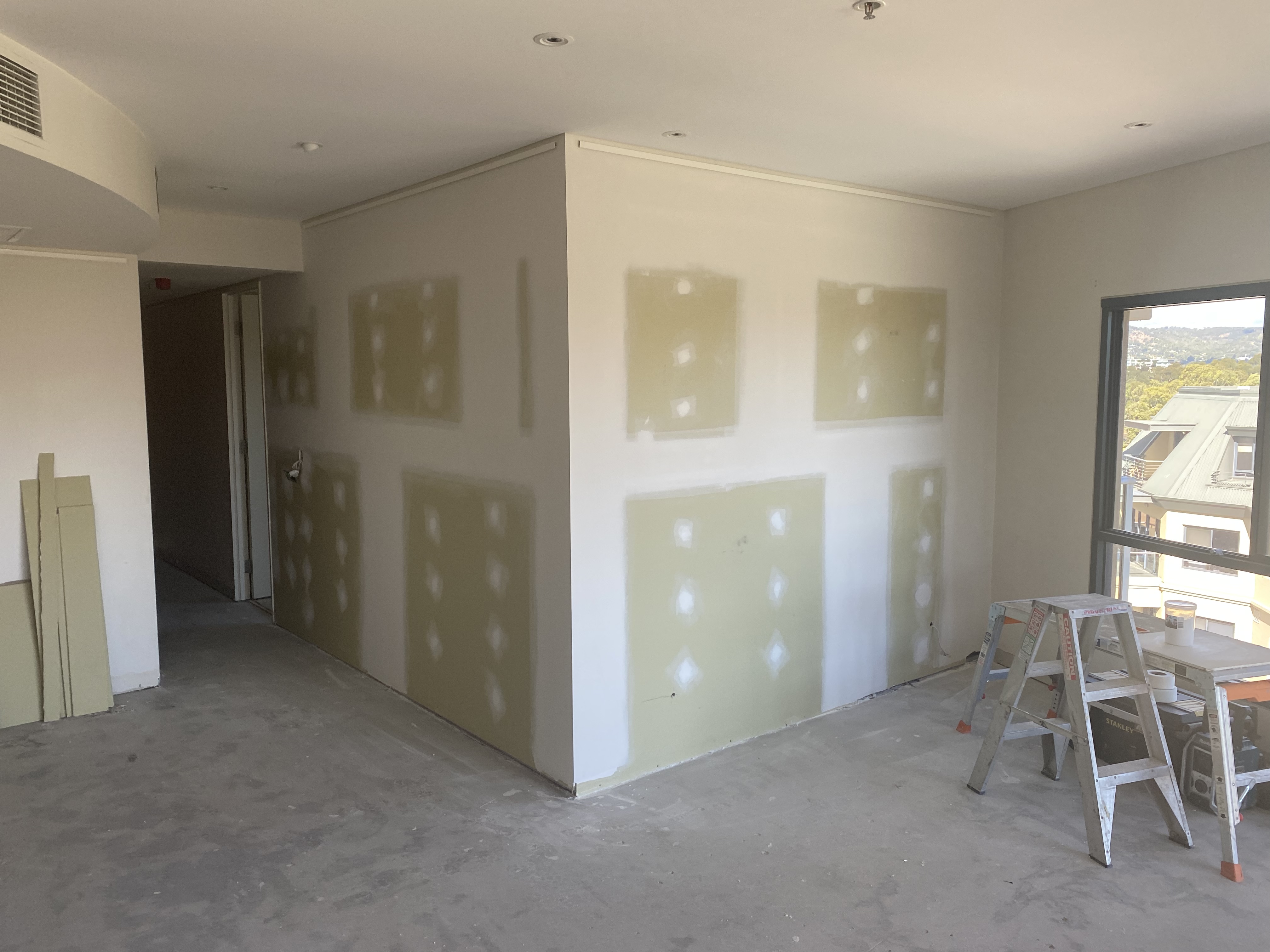 Before: Plain plaster drywall wall before wainscoting renovation